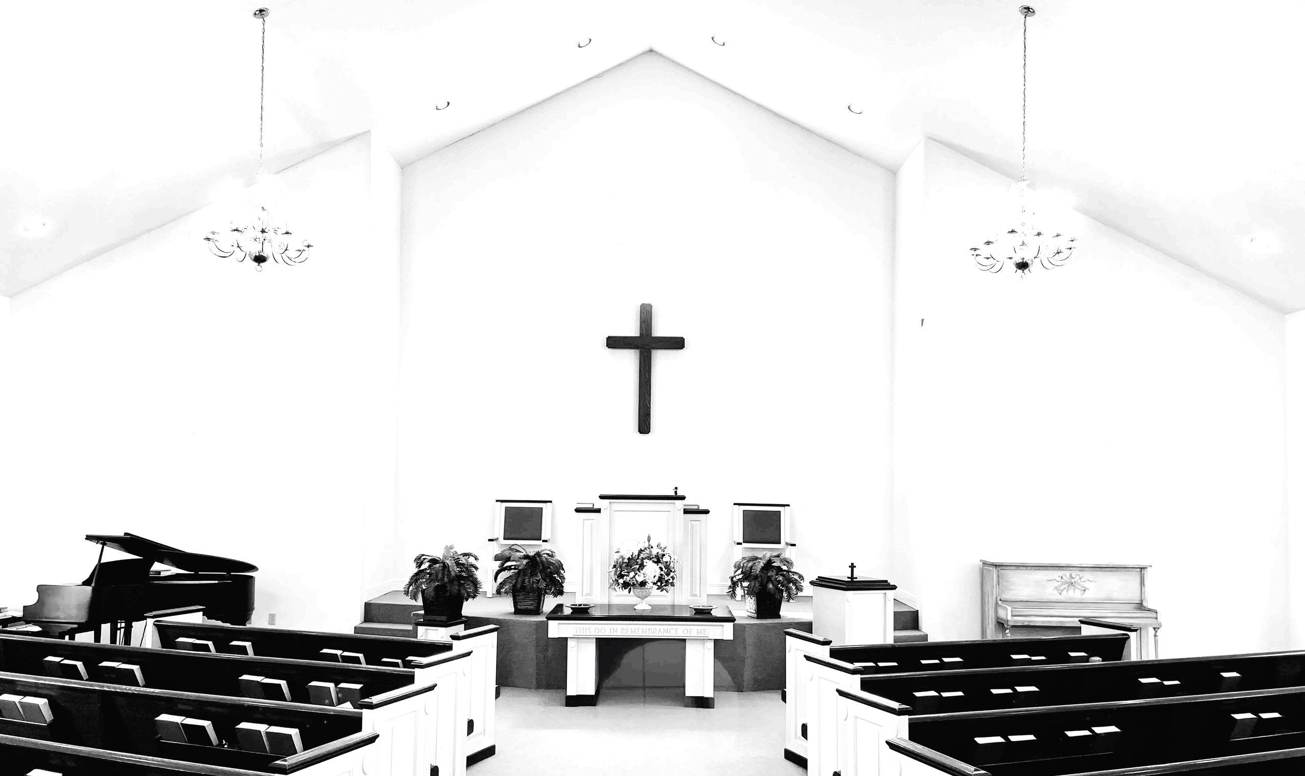 The sanctuary at Faith PCA, with the cross above the pulpit and the Lord's Supper table